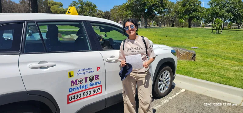 Learner in a beige shirt beside the Motor Driving Guru SUV in Adelaide